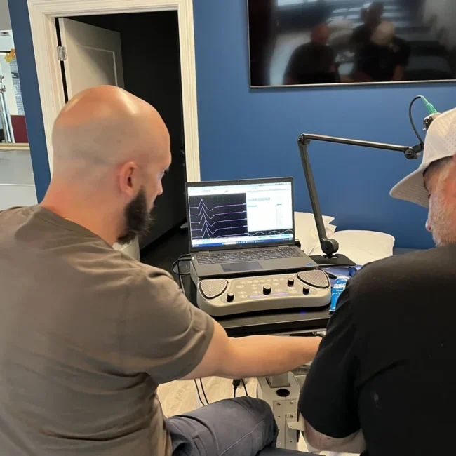 neuromuscular specialist conducting EMG test with patient Chicago